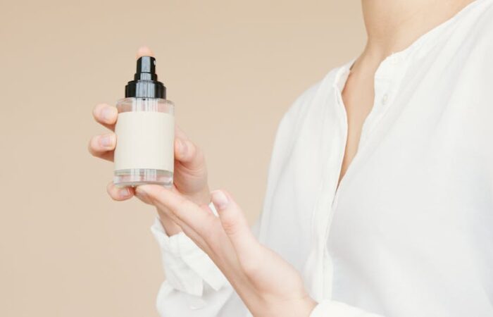 Professional close up of a custom packaging dieline template on a designers screen showing bleed areas fold lines and safety zones marked in red and blue with a luxury product mockup overlaid