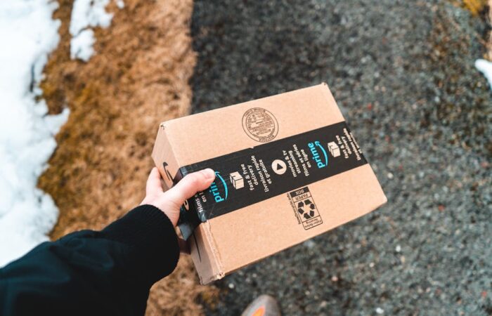 Vibrant cityscape at dusk with delivery trucks e commerce packages stacked on sidewalks and diverse urban consumers holding branded custom boxes emphasizing density and convenience