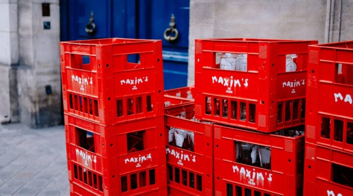 Vibrant cityscape at dusk with delivery trucks e commerce packages stacked on sidewalks and diverse urban consumers unboxing branded products emphasizing fast paced urban delivery and customization