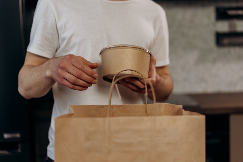 Close-up of sustainable packaging materials like recyclable paper boxes, compostable bags, and foil-stamped eco-friendly designs, arranged in a circular pattern symbolizing the circular economy